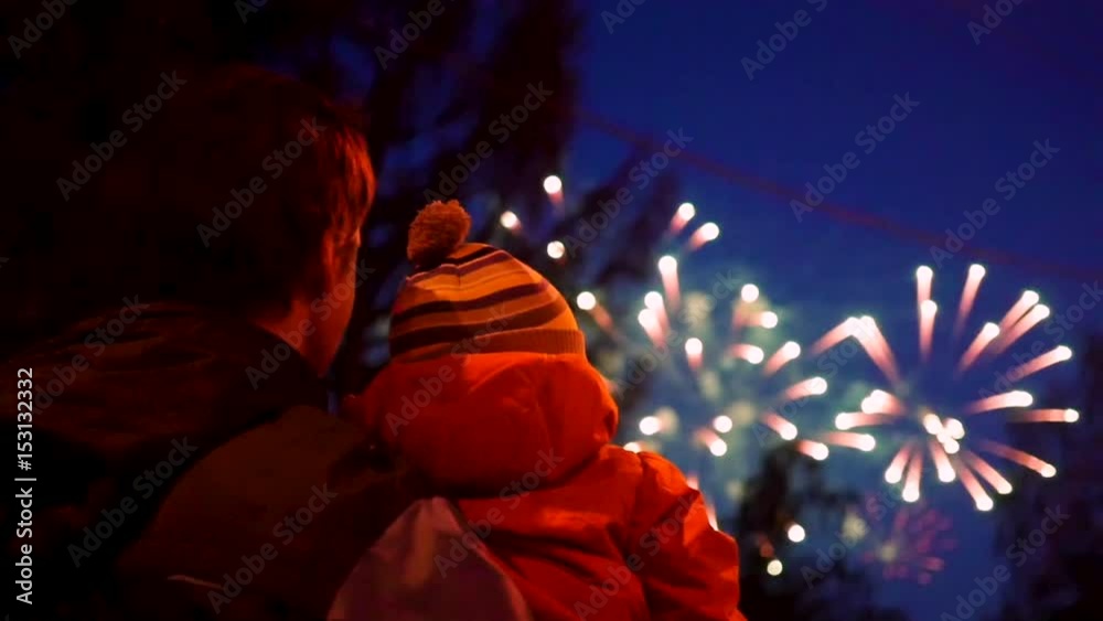 family look at the sky at the fireworks. The night sky in lights