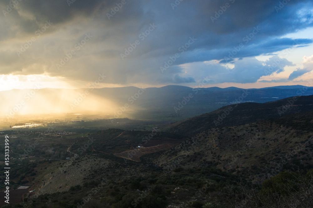 Magnificent view of the Golan Heights, the rays of the setting sun make their way through the clouds