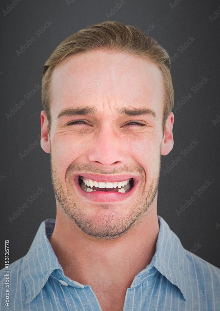 Man crying against grey wall Man crying against grey wall