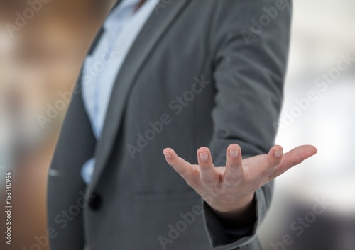 Midsection of businesswoman gesturing in office