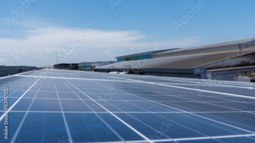 solar cell panel on roof house with strong sun and blue sky