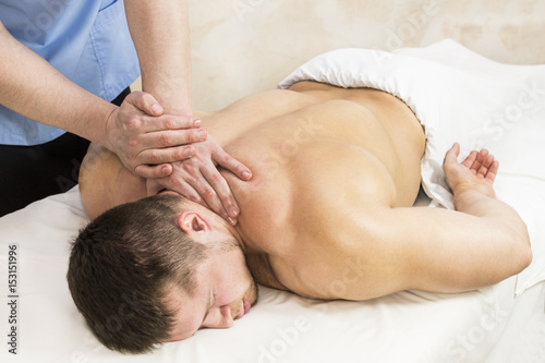 Young man on wellness treatments sports massage 