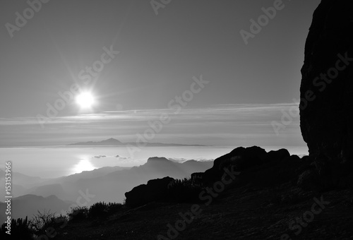 Sunset from summit of Gran canaria and Tenerife island in the distance  Canary islands  monochrome mode
