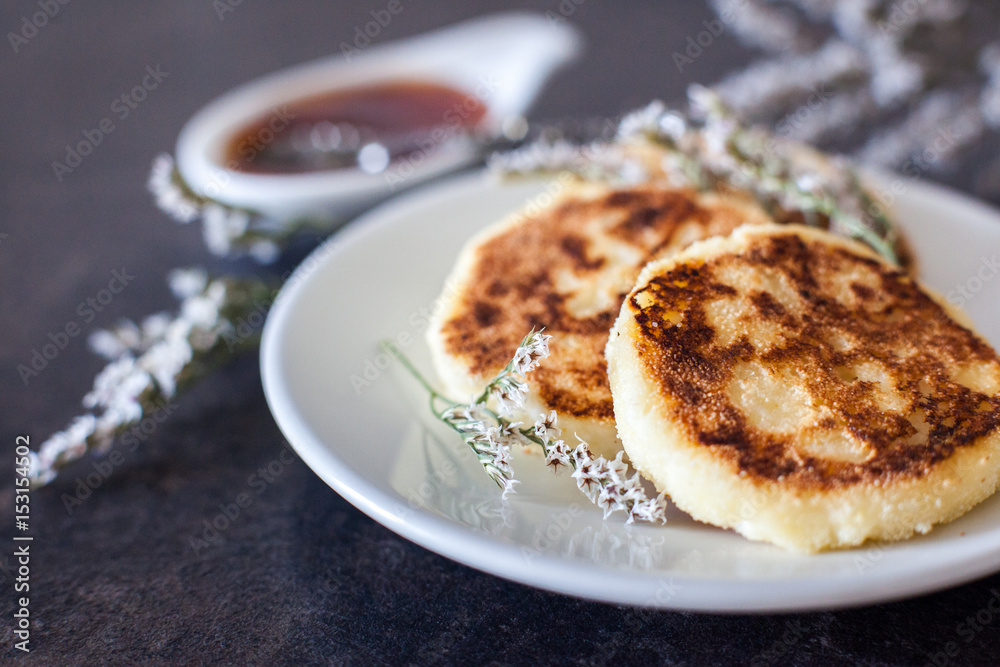 Cottage cheese pancakes with sour cream and strawberry sauce