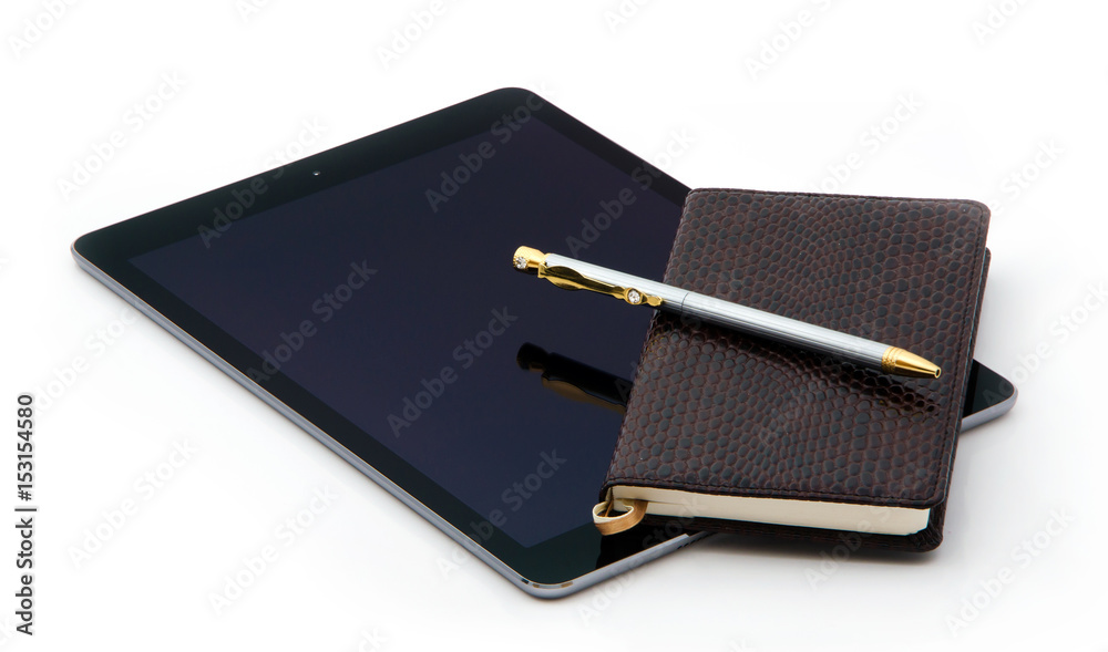 Tablet and Notepad of crocodile leather and expensive pen made of gold of silver with diamonds. Tablet and Notepad of crocodile leather and expensive pen made of gold of silver with diamonds.