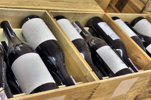 Bottle of red and white wine in wooden box