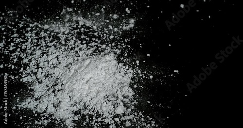 Drug, Cocaine falling against black background, Slow motion 4K photo