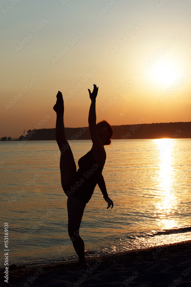 Silhouette of elegant lady dancing at the beach during sunset Stock ...