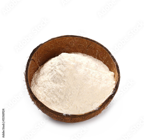Pile of wheat flour in coconut shell isolated on white