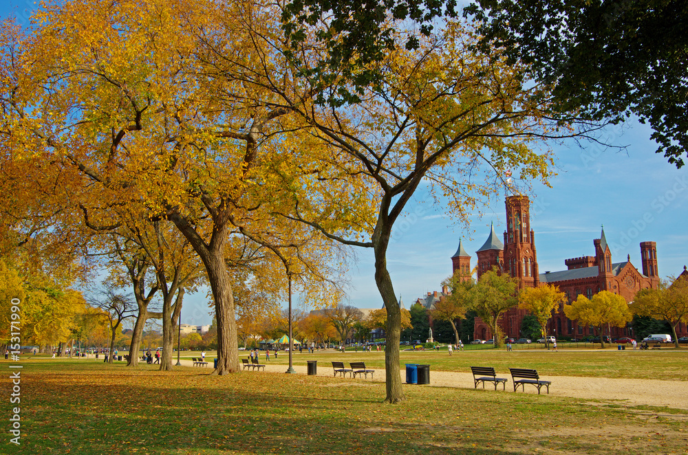 The National Mall in Washington DC in a bright sunny day with Smithsonian Castle at the background