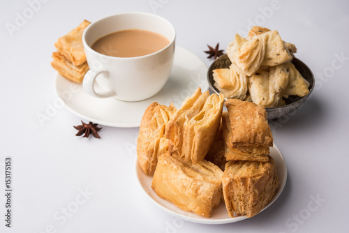 indian khari or kharee or salty Puff Pastry Snacks and tutti frutti toast, served with indian hot tea, selective focus texture photo