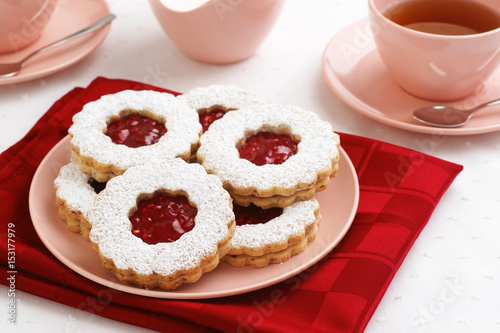 Raspberry Filled Linzer Torte Cookies with Hot Tea