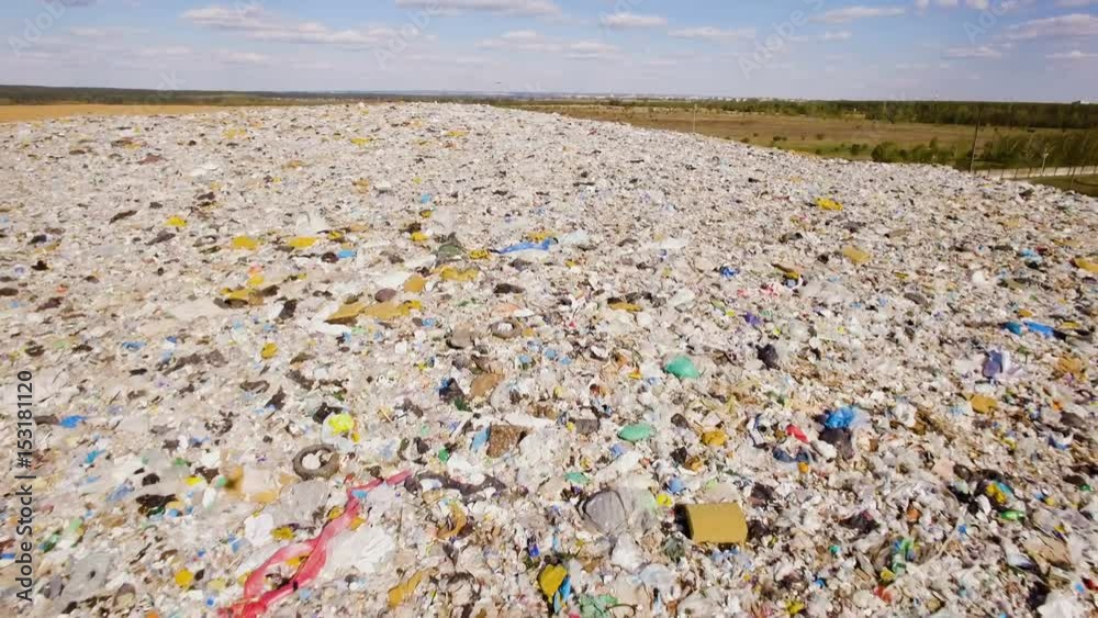 a big mountain of household garbage on the background of blue sky with clouds a big mountain of household garbage on the background of blue sky with clouds