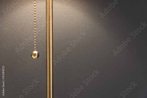 Lamp with a gold chain of the switch in the room