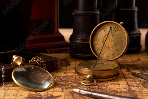 Old vintage retro compass on ancient world map. Vintage still life. Travel geography navigation concept background.