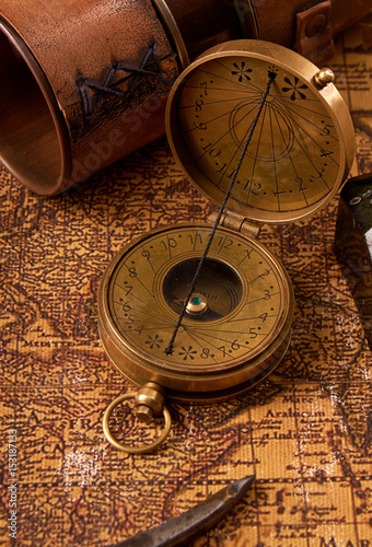 Old vintage retro compass on ancient world map. Vintage still life. Travel geography navigation concept background.