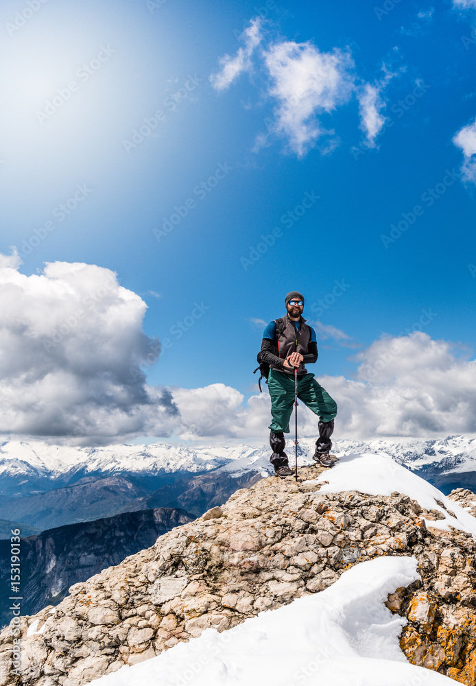 Hiking in Alps mountains. Man Traveler with Backpack hiking in the Mountains. mountaineering sport lifestyle concept
