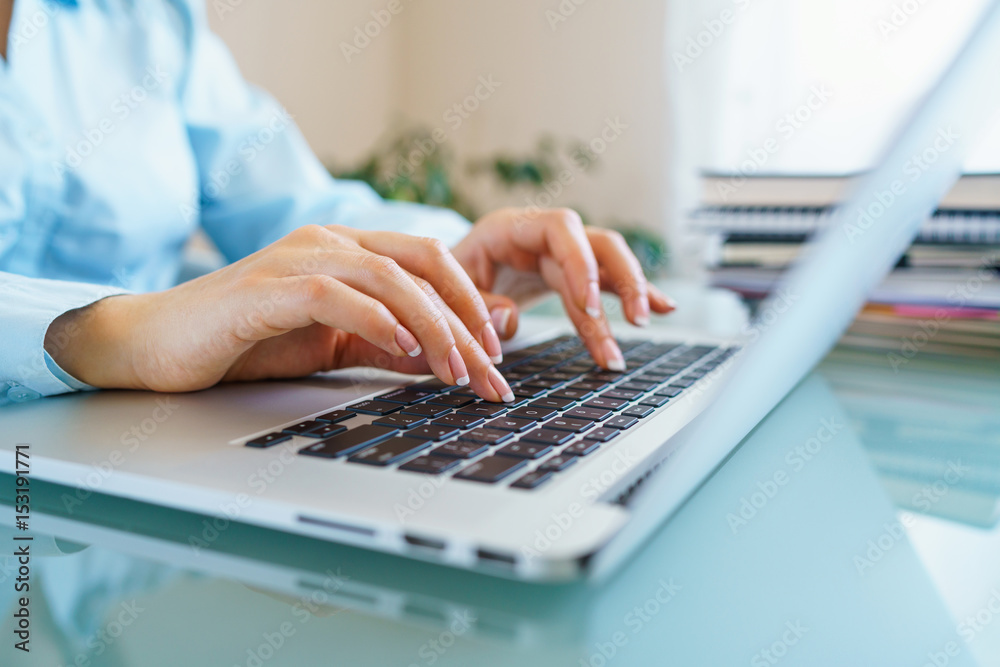 Woman office worker typing on the keyboard Woman office worker typing on the keyboard