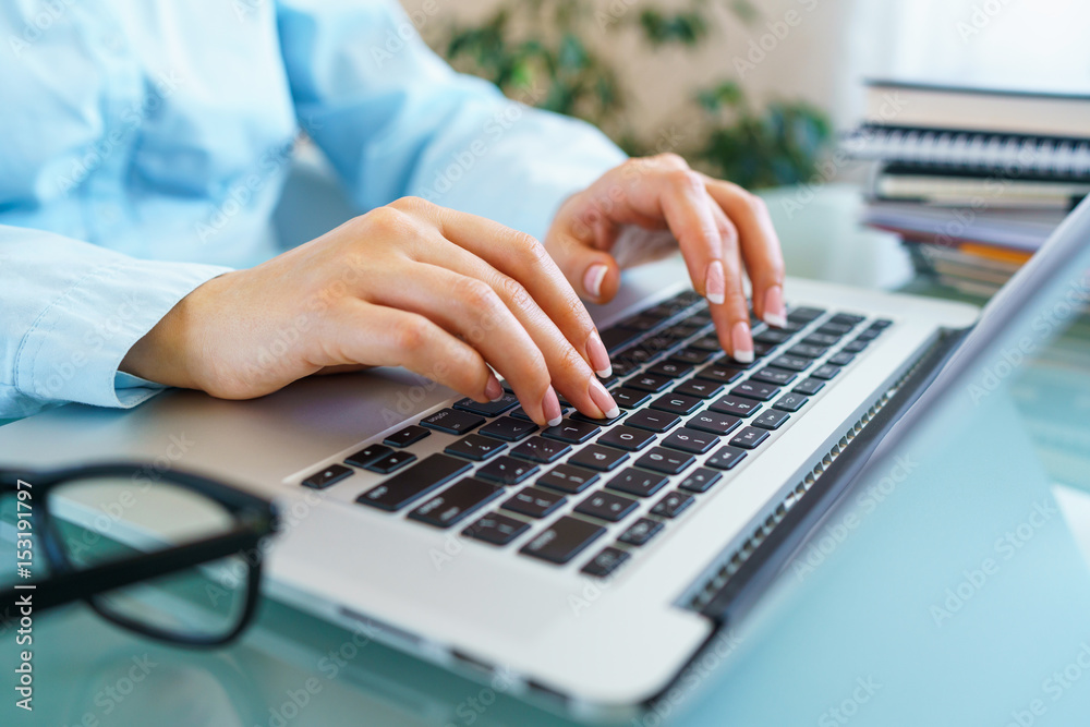 Woman office worker typing on the keyboard Woman office worker typing on the keyboard