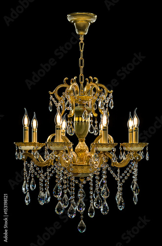 Contemporary gold chandelier isolated on black background. Crystal chandelier
