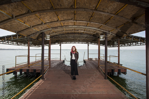 Young girl posing on pier at Lake Siutghiol  © FotoGroupMedia