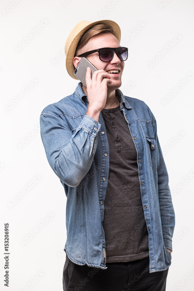 Tourist talking to mobile in hat and sunglasses on white background Tourist talking to mobile in hat and sunglasses on white background