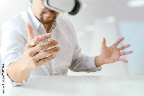 businessman wearing virtual reality goggles in modern office with Smartphone using with VR headset