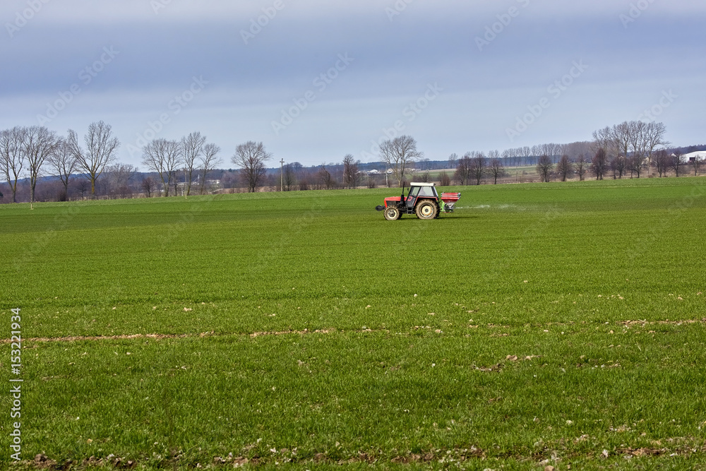 Tractor, photographed in the agricultural field during the processing of Pesticides - Poland Tractor, photographed in the agricultural field during the processing of Pesticides - Poland