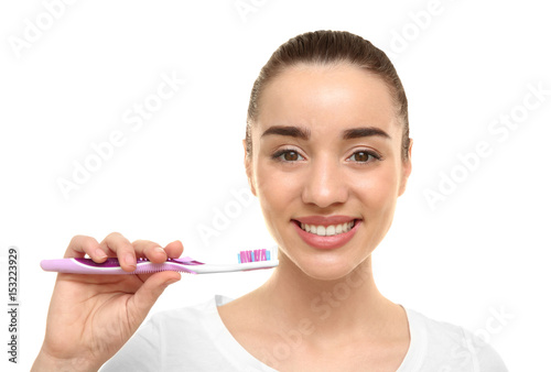 Young beautiful woman brush...