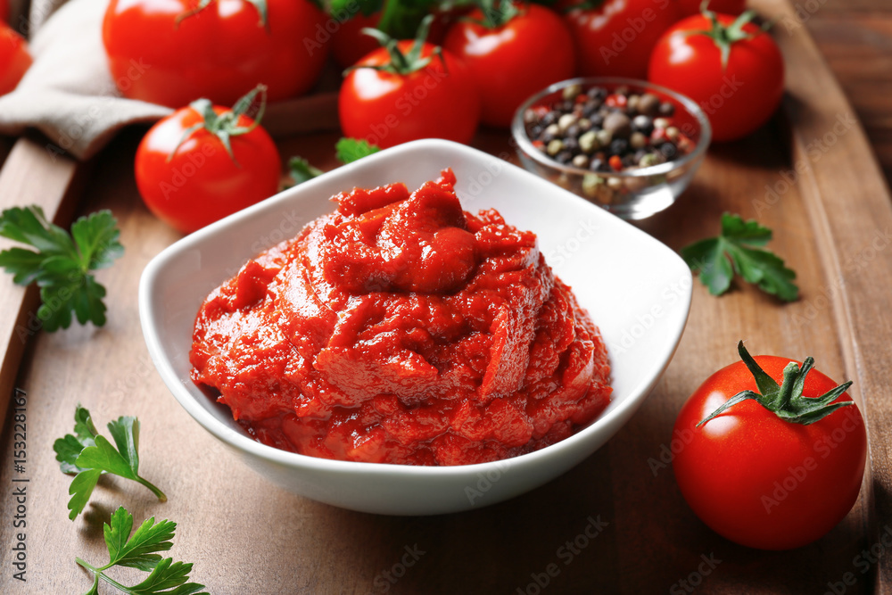 Delicious tomato paste in bowl with ingredients on tray, closeup Delicious tomato paste in bowl with ingredients on tray, closeup