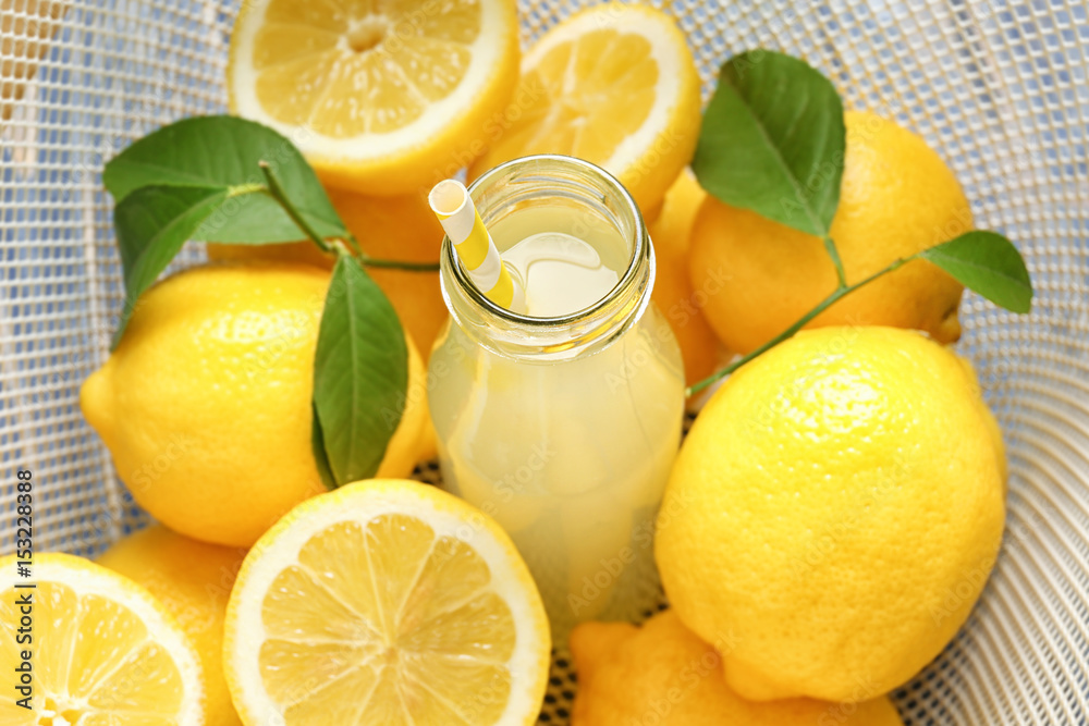 Delicious lemon juice in bottle with citruses Delicious lemon juice in bottle with citruses