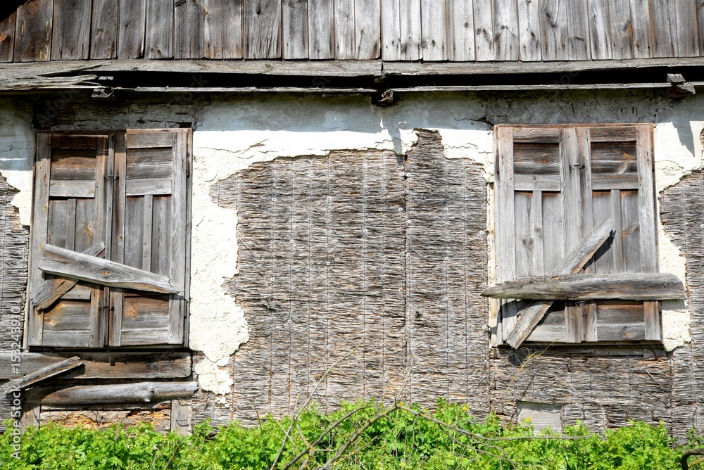 Window of an old wooden abandoned house destroying in the wilderness