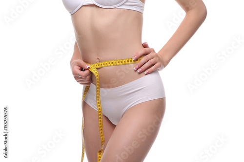woman measuring waist on blue background