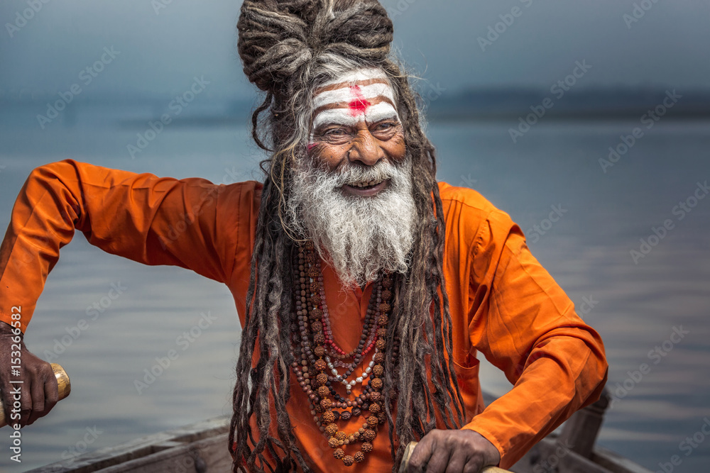 Portrait of sadhu rowing in the boat, Varanasi, India.