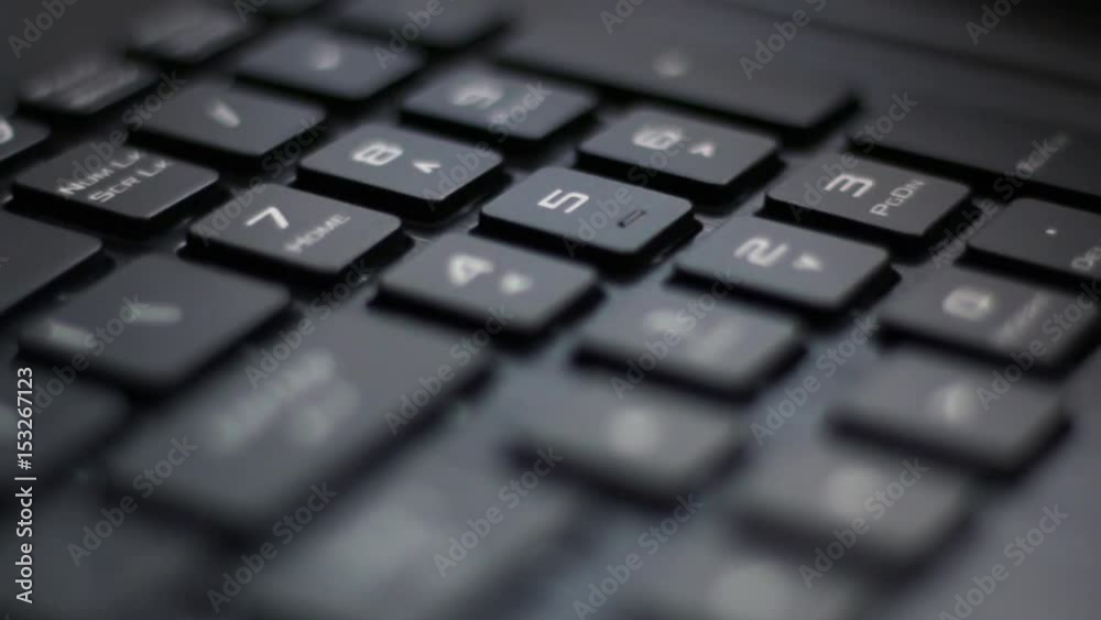 Number pad of back lit laptop keyboard with red pulsing nahimic RGB keys flashing side to side Number pad of back lit laptop keyboard with red pulsing nahimic RGB keys flashing side to side