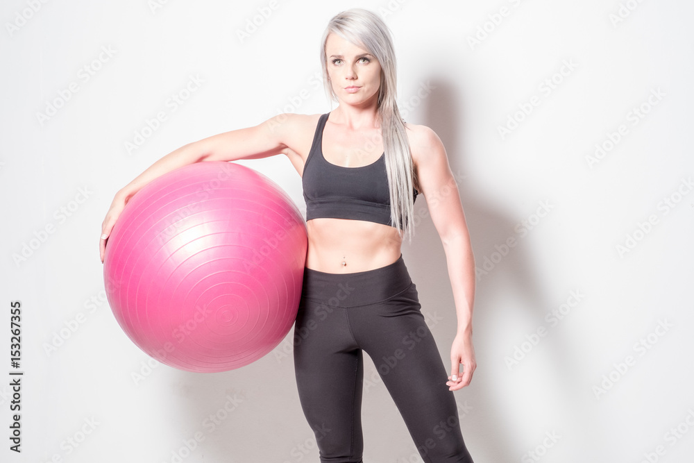 athletic looking blonde female with an exercise ball athletic looking blonde female with an exercise ball