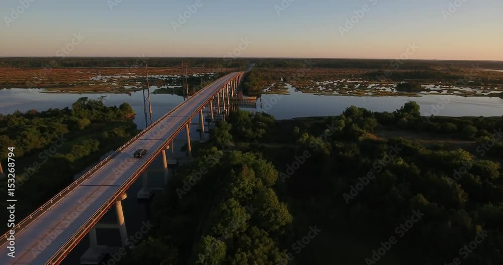 An early morning sunrise aerial establishing shot of the Topsail Island Bridge over the Intracoastal Waterway. An early morning sunrise aerial establishing shot of the Topsail Island Bridge over the Intracoastal Waterway.