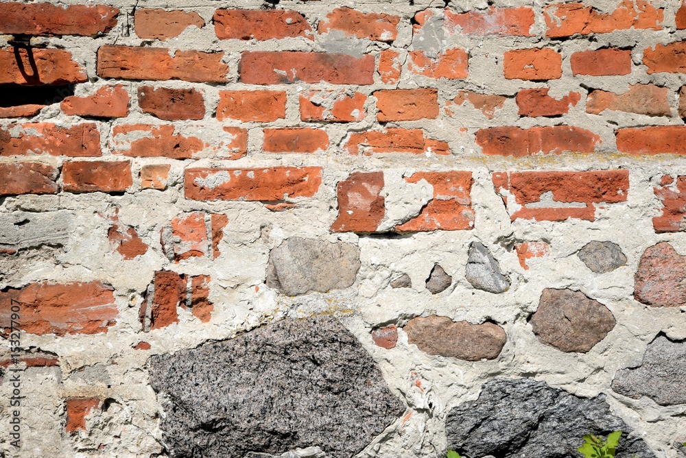 Old brick wall with brick mortar and stones