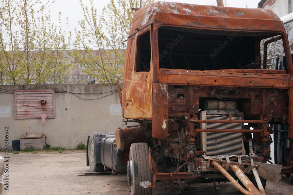 Rusty truck - a tractor after a fire and accident
