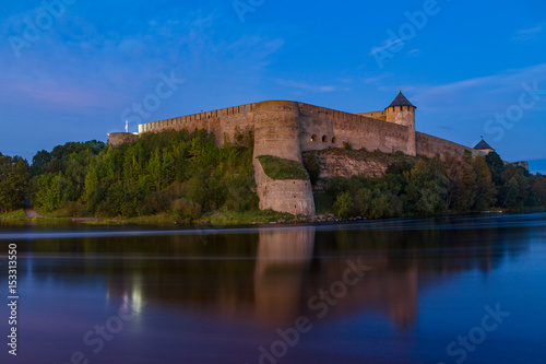 Ivangorod medieval fortress on the river Narva at blue hour, Estonia and Russia border.