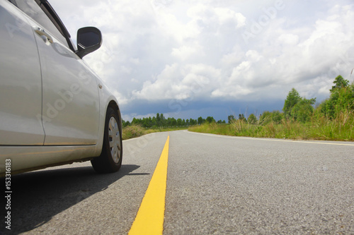 Stock Photo - Car on country road in forest