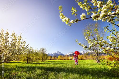 Woman in red costume at cherry blossom