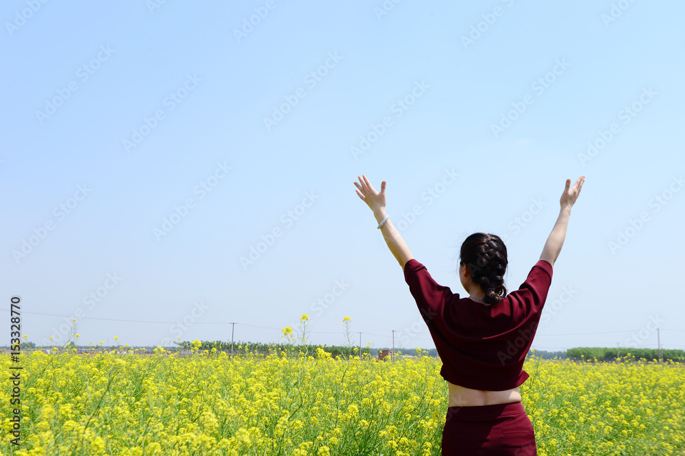 A woman in the yellow flowers A woman in the yellow flowers