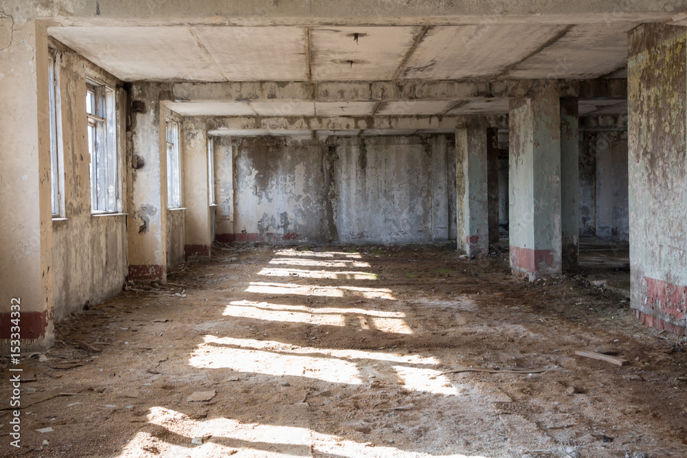 Inside destroyed building, ruins, after war concept, sunny light on the floor