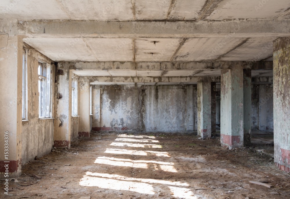 Inside abandoned building, ruins, after war concept, sunny light on the floor