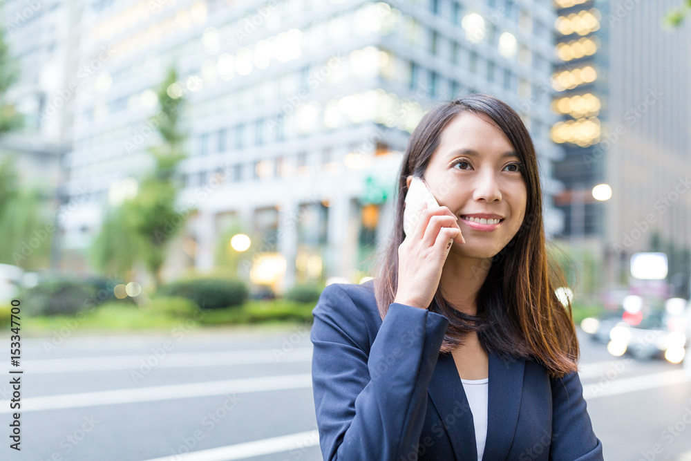 Businesswoman talk to cellphone in Tokyo city