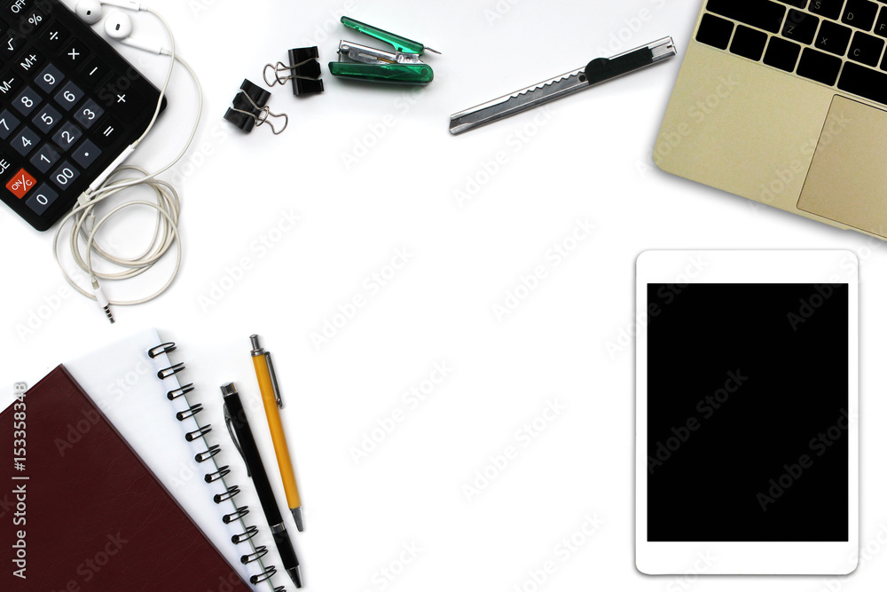 White office desk with tablet computer with black screen, pen, notepad, laptop computer and supplies. Top view with copy space White office desk with tablet computer with black screen, pen, notepad, laptop computer and supplies. Top view with copy space