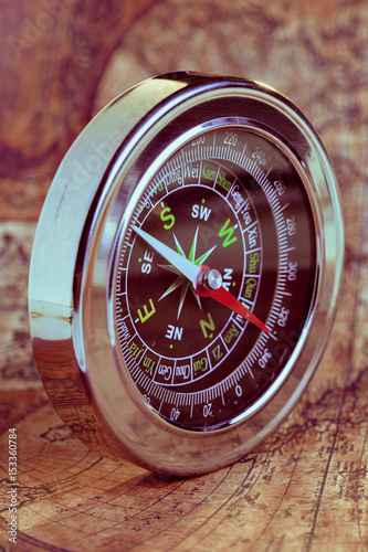 Old compass on vintage map