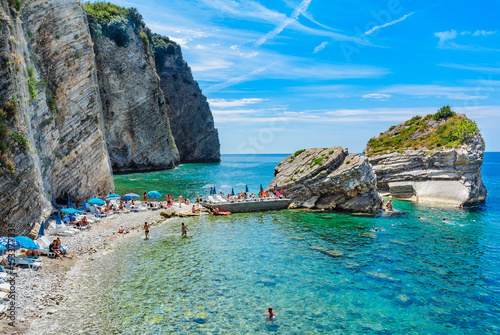 The beach near the rocky shore of the island of St. Nicholas. Budva, Montenegro. photo