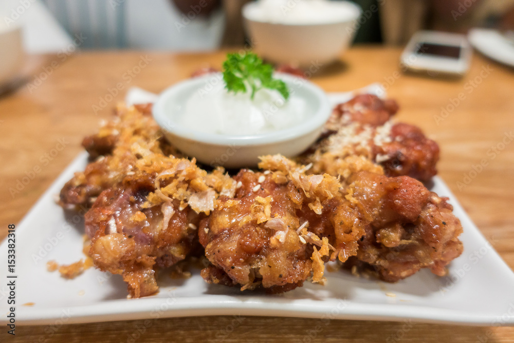 Korean style spicy sauce deep fried chicken wing serve ..top view with copy space.selective focus Korean style spicy sauce deep fried chicken wing serve ..top view with copy space.selective focus